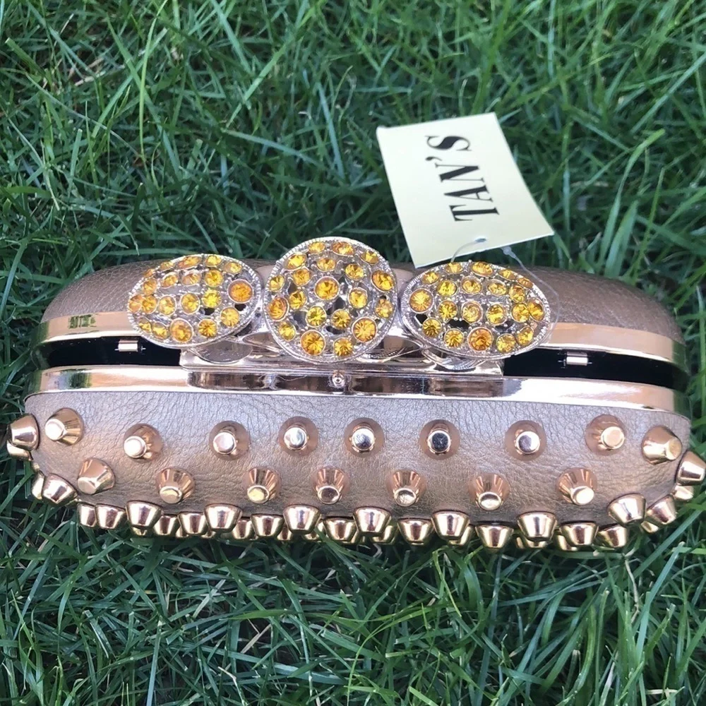 Skulls knuckles ring handles, rhinestone spikes studded clutch.